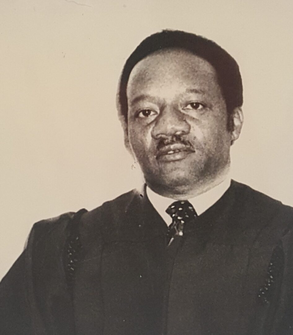 Black and white portrait of a man in formal attire.