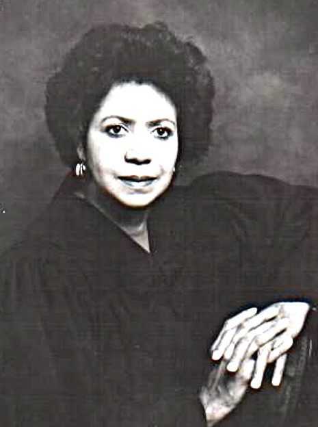 Black and white portrait of a woman with a calm expression.