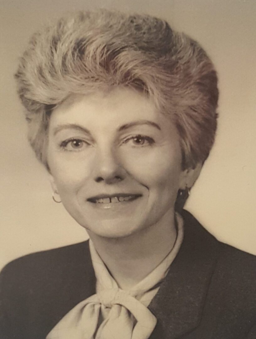 Black and white portrait of a confident woman with short hair.