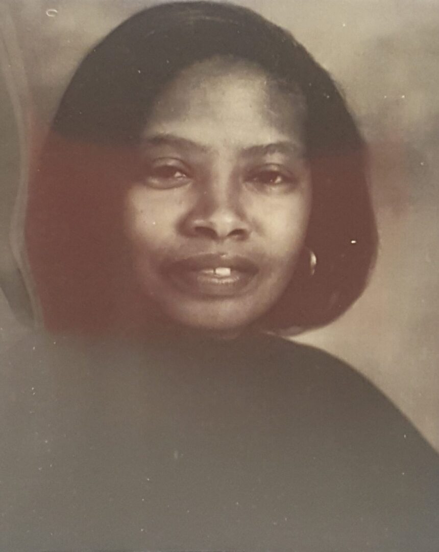Portrait of a woman with a calm expression and short hair.