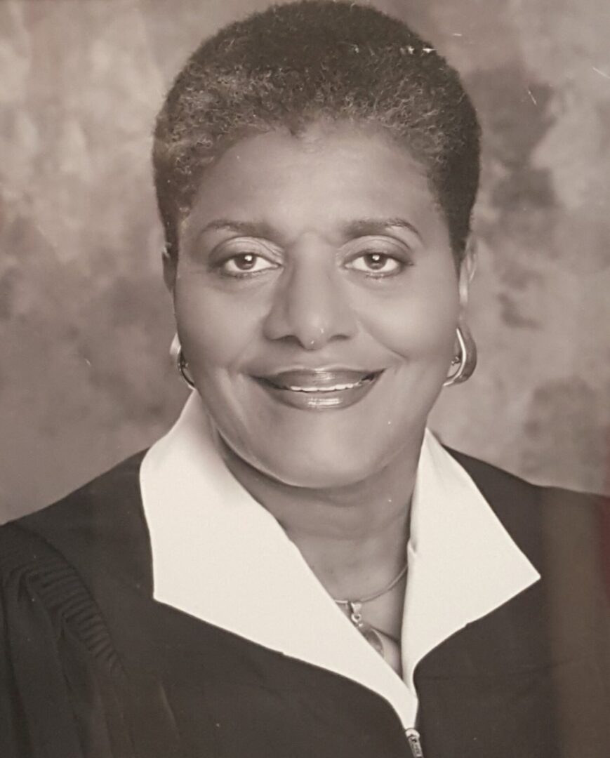 Portrait of a smiling woman in formal attire.