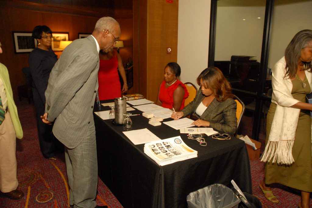 People registering at an event table
