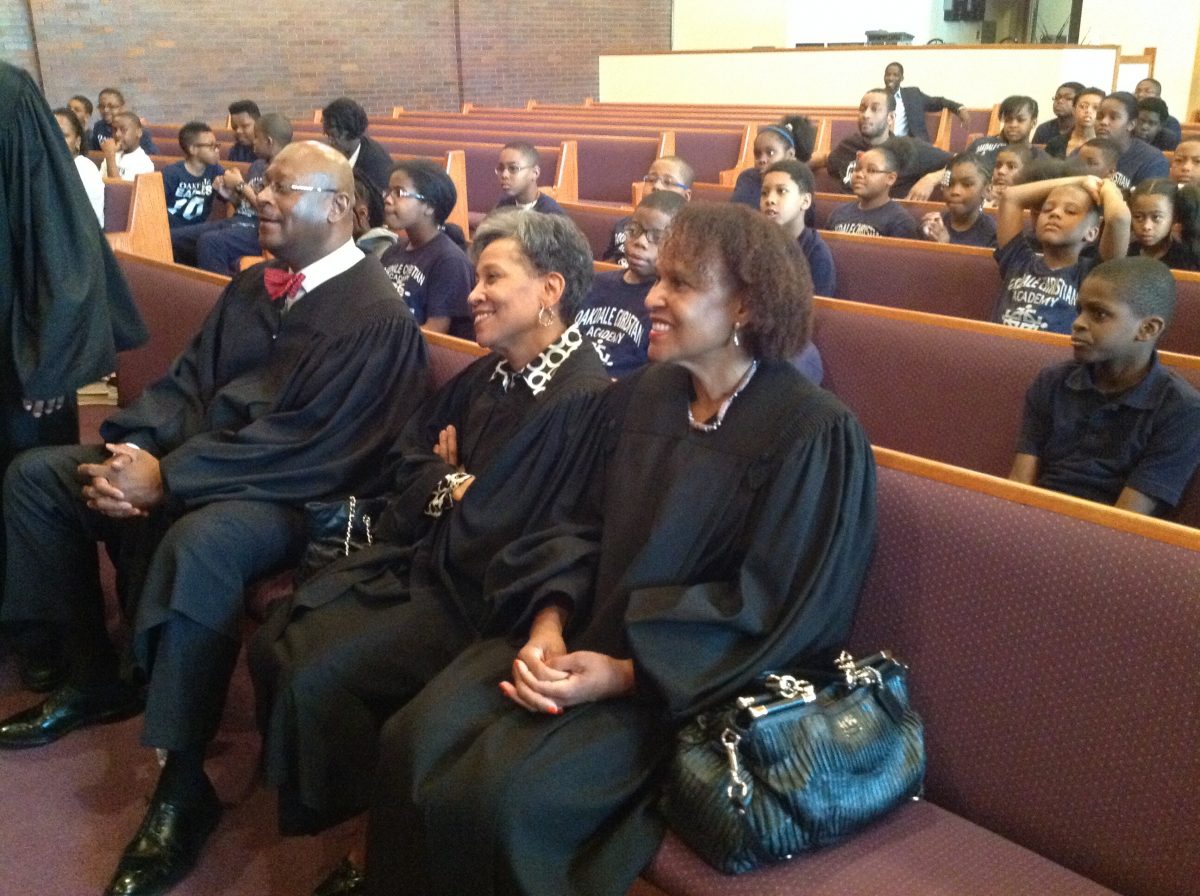 People sitting in pews inside a church during a service.