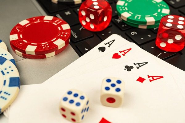 Poker essentials including aces, dice, and chips on a table.
