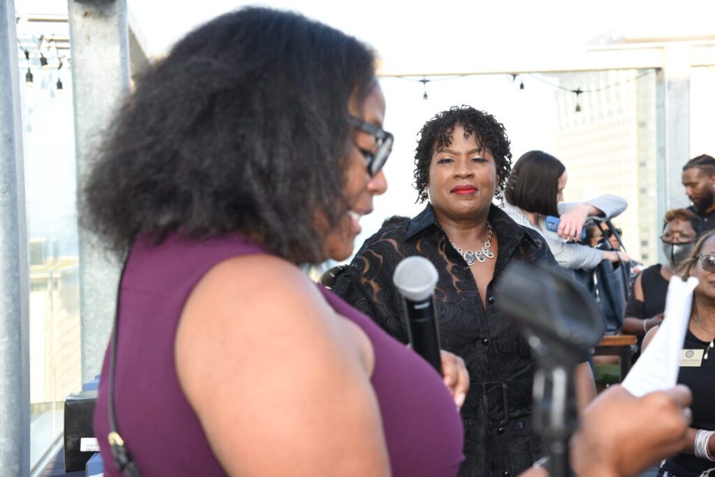 Two women engaged in conversation at an event.