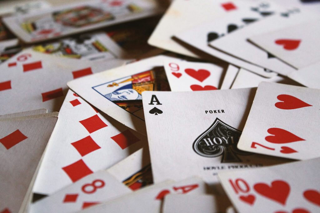 Close-up of scattered playing cards including an Ace of spades.