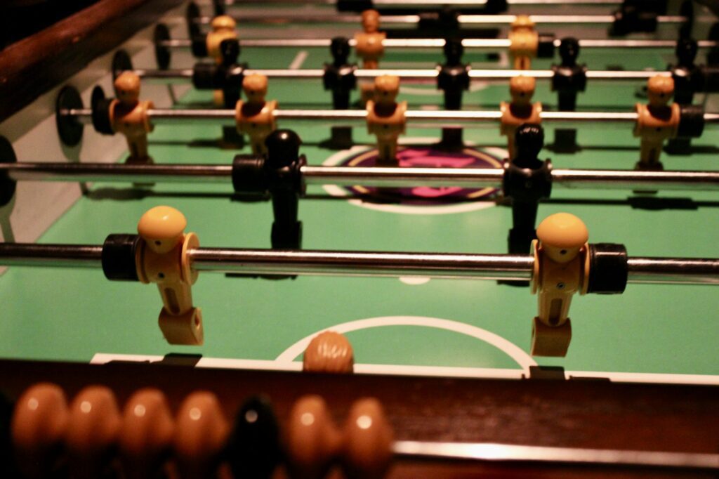 Close-up of foosball players on a table game.