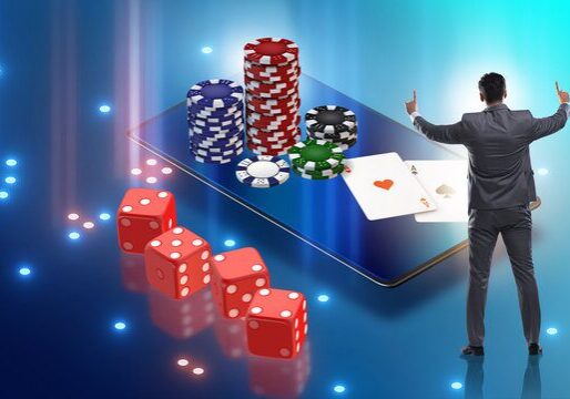 A man stands next to a large smartphone screen displaying poker chips, cards, and dice.