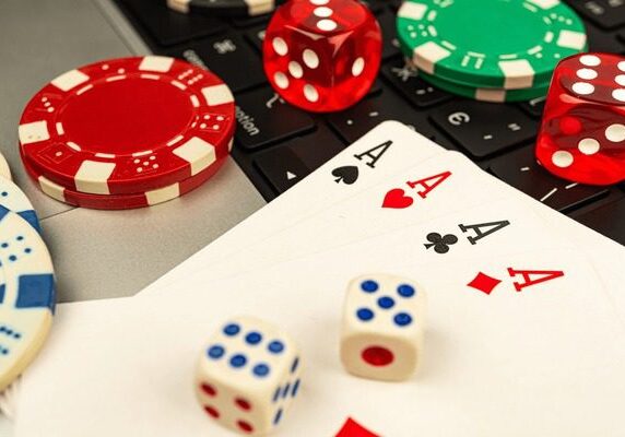 Poker essentials including aces, dice, and chips on a table.