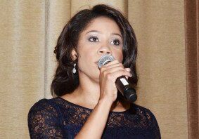 Woman in black dress with microphone