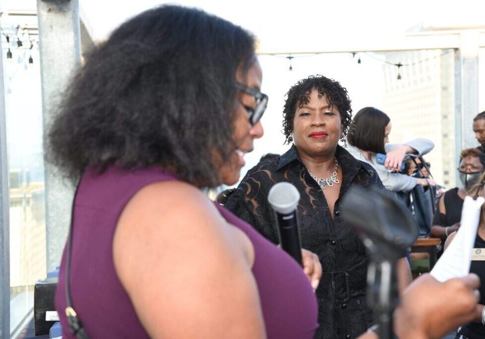 Two women engaged in conversation at an event.