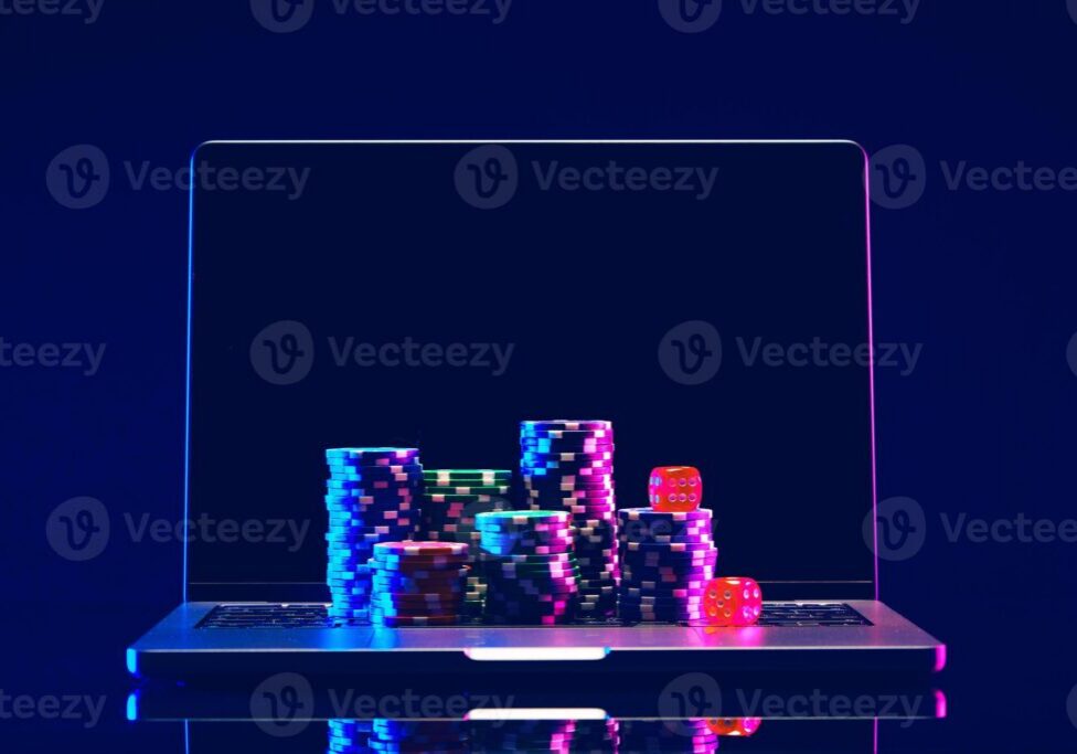 Colorful poker chips stacked on a reflective surface with a dark background.