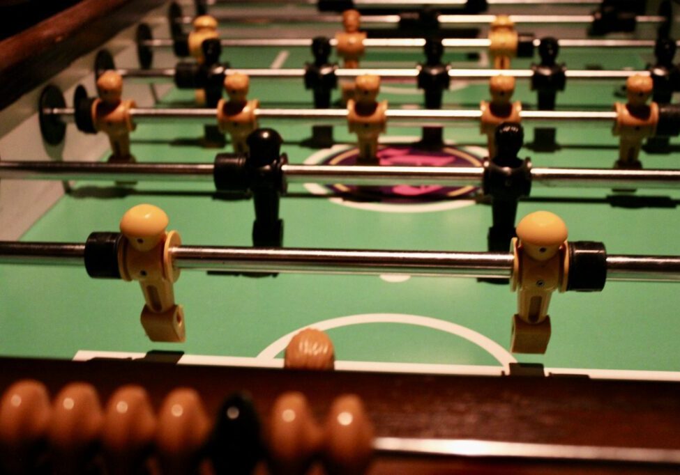 Close-up of foosball players on a table game.